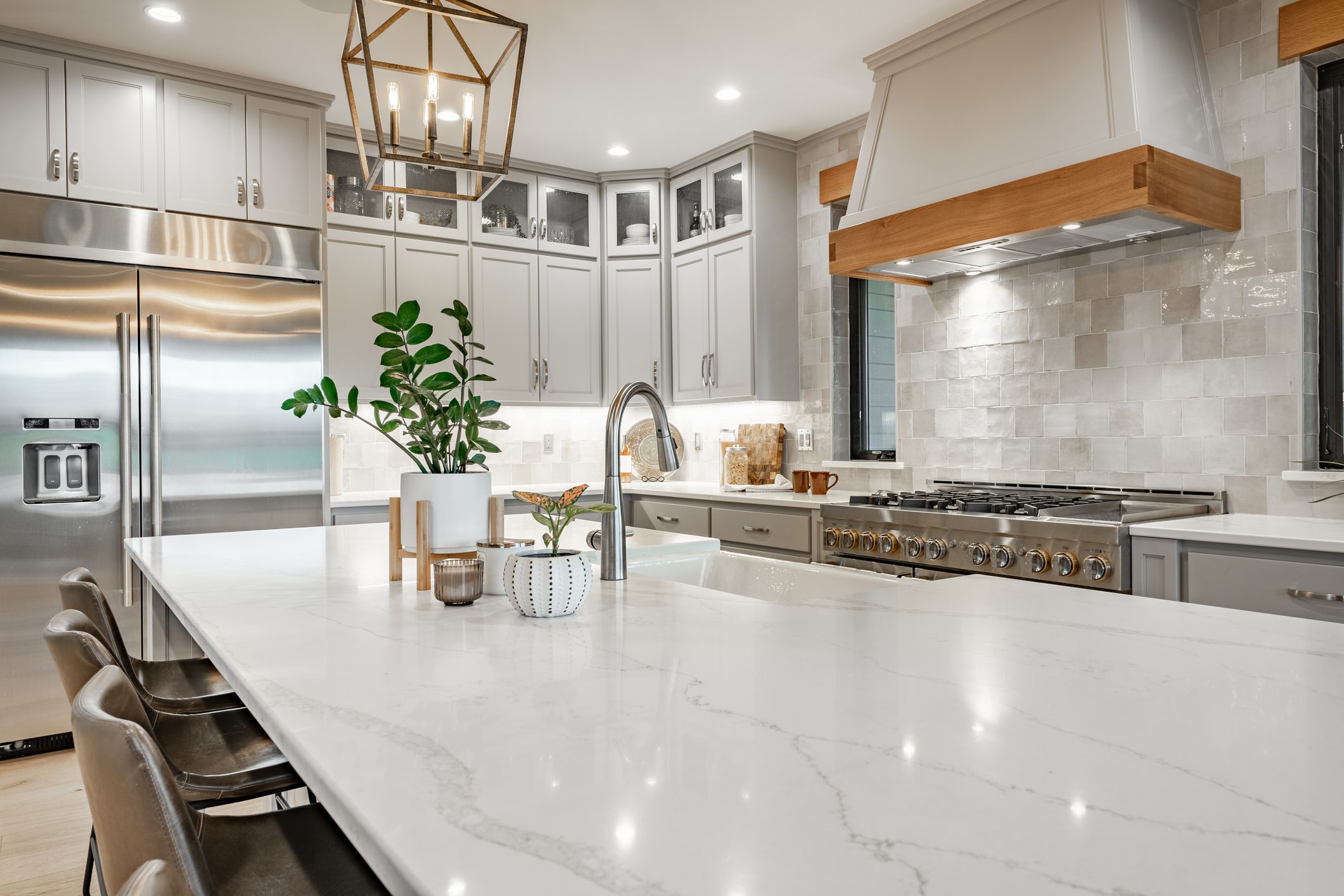 A kitchen with white counters and stainless steel appliances.